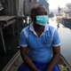 A man wearing a face mask sits in a traditional canoe at the Makoko community in Lagos, Mar. 9, 2020.
